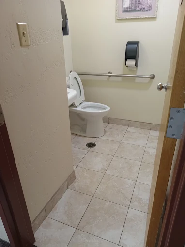 Sanitized, accessible commercial restroom with grab bars